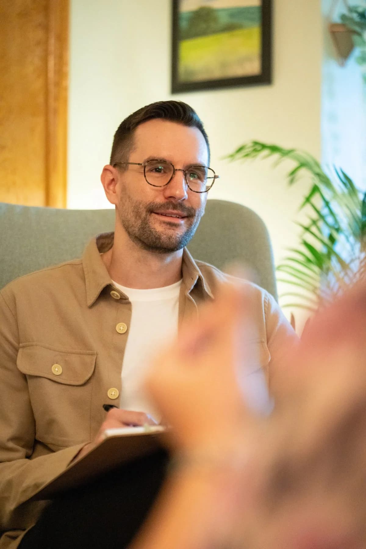 Garrett Gooch, Registered Psychologist, smiling during a therapy session in Edmonton