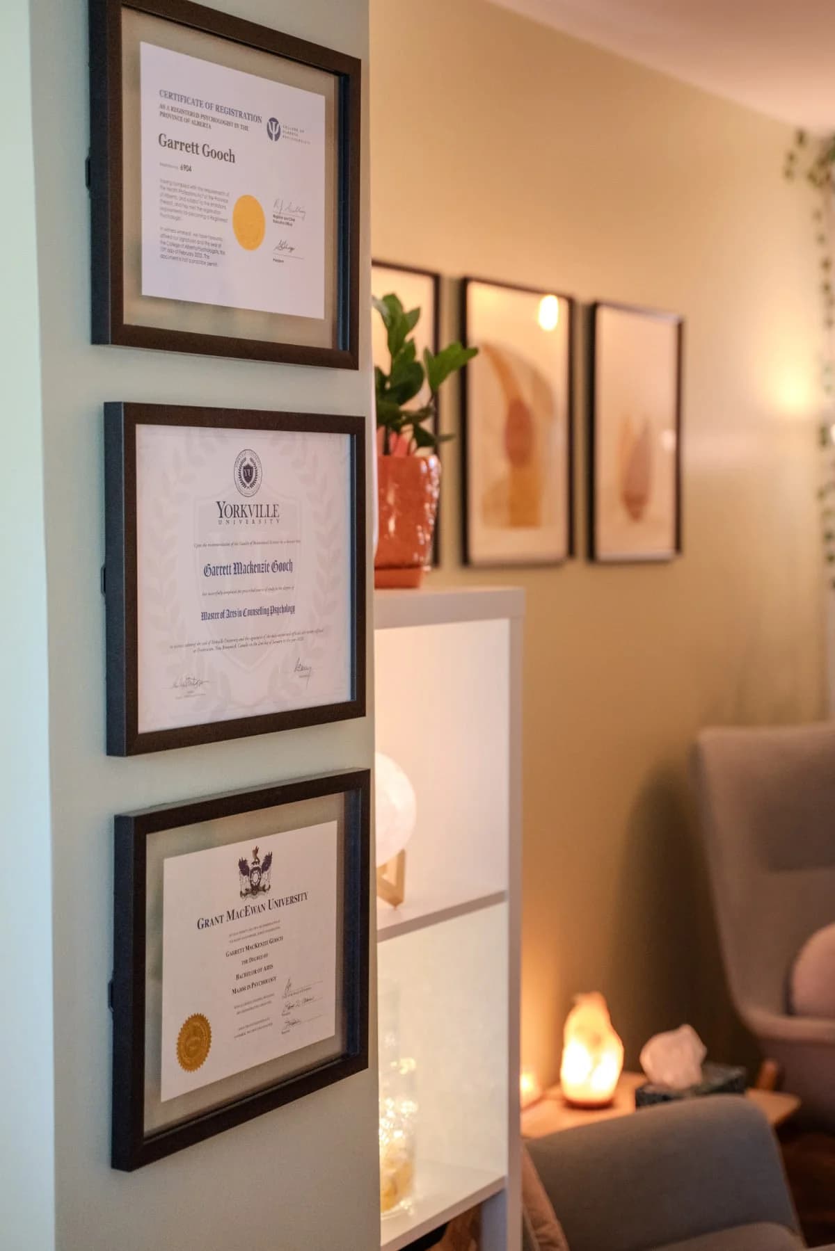Garrett's framed credentials: College of Alberta Psychologists, Yorkville University, MacEwan University